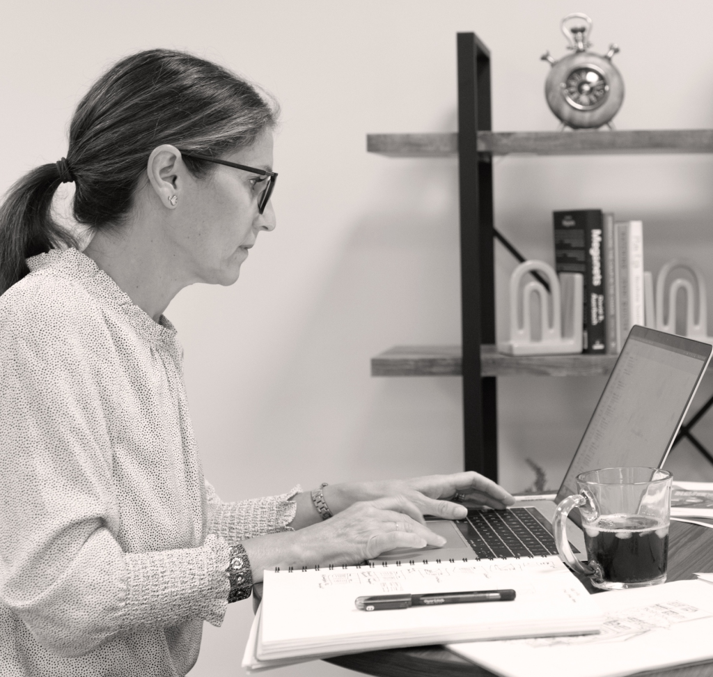 Luise Faust founder of FAUST Design Studio working at desk